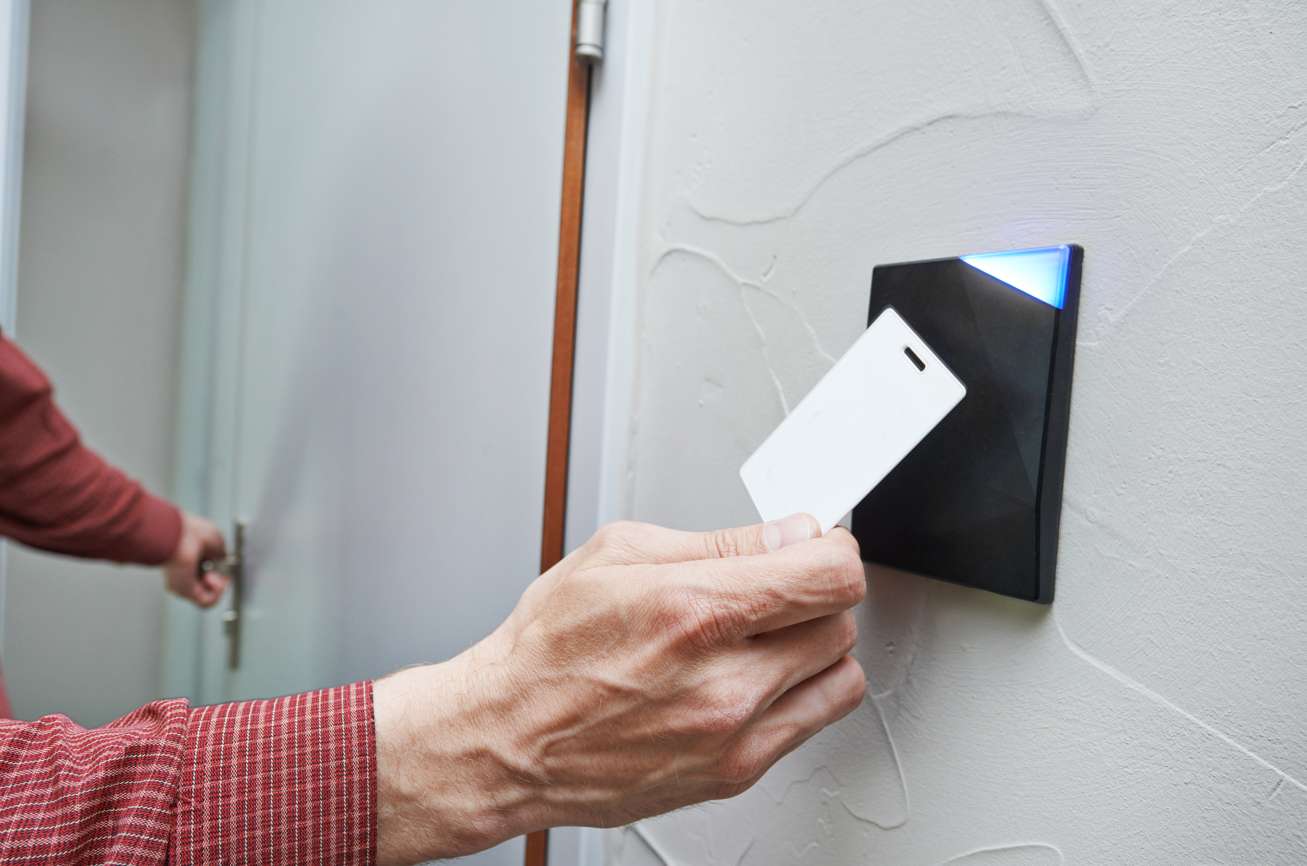 Key card being used to unlock security door.